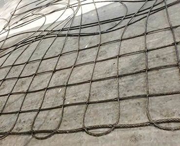 A piece of square rope mesh of inter-woven type is on the floor.