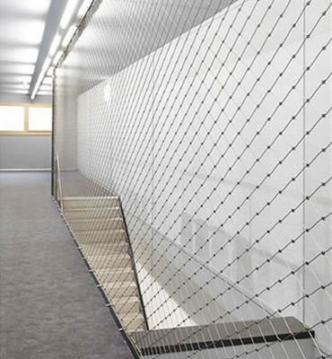 Stainless steel ferrule rope mesh is installed beside a passage.