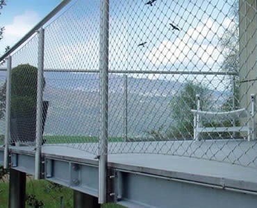 Stainless steel ferrule rope mesh is installed as balcony balustrade infill.